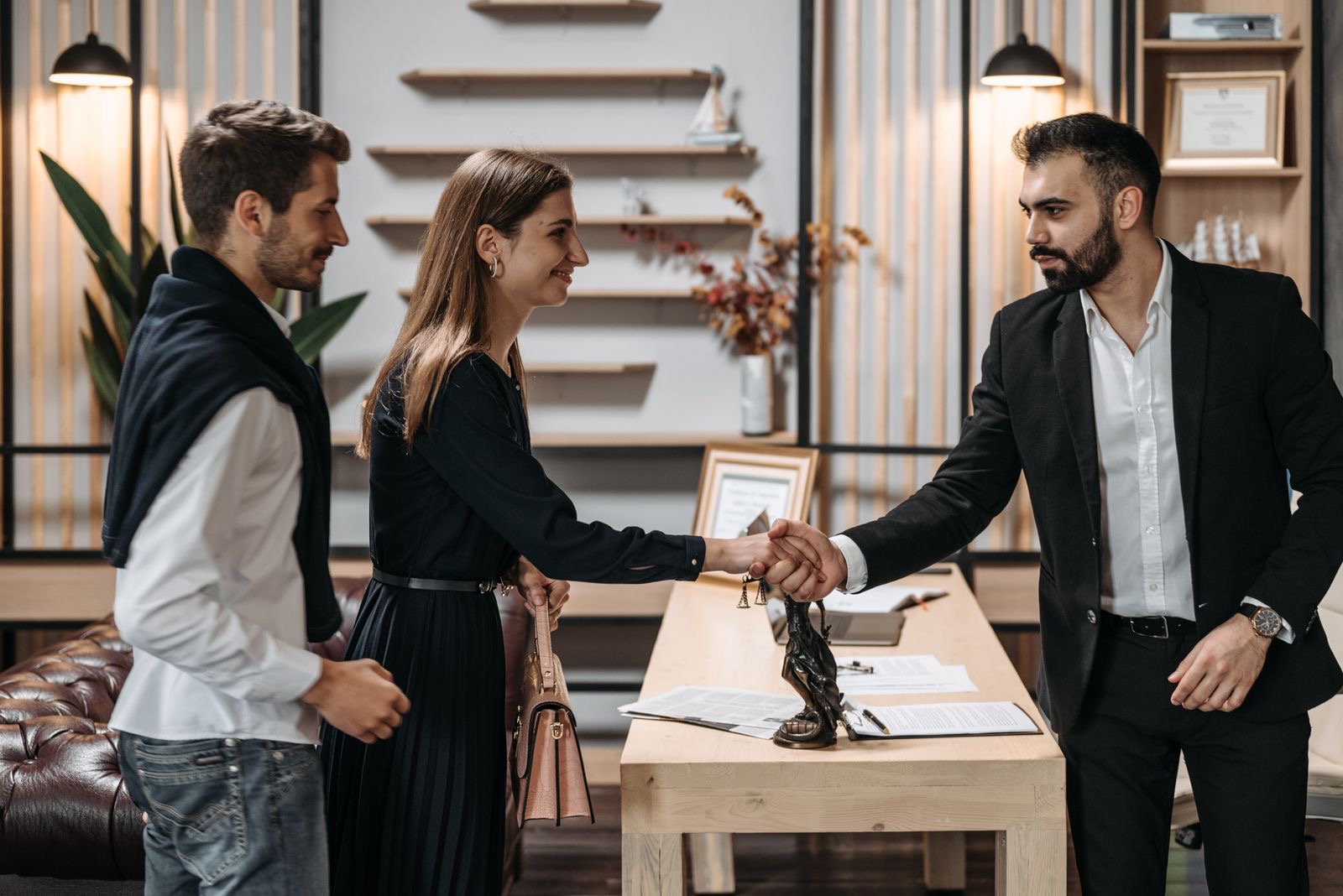 A lawyer shaking hands with clients in the office
