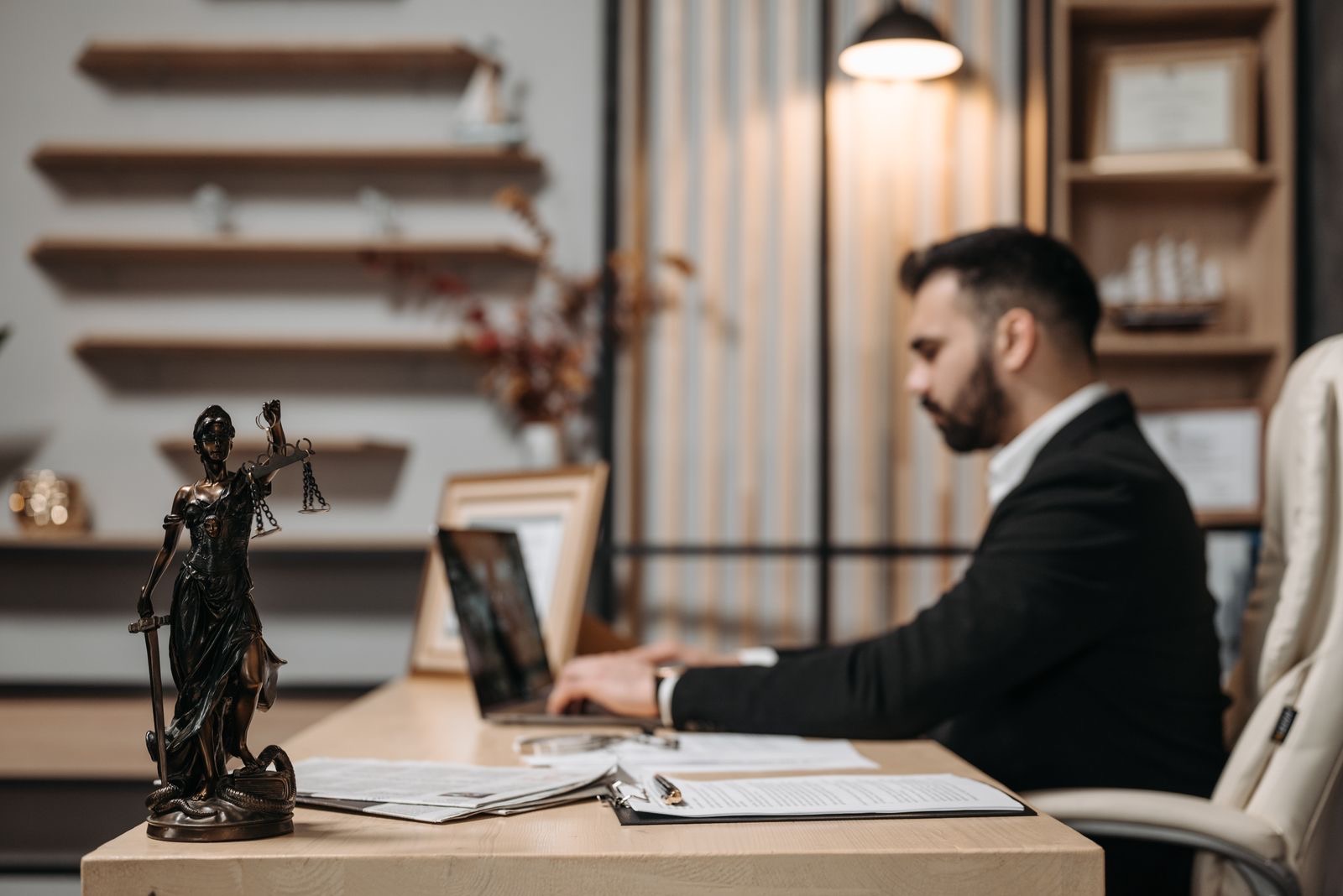 A lawyer working on a laptop in a law office